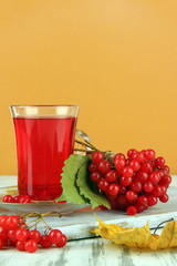 Red berries of viburnum and cup of tea