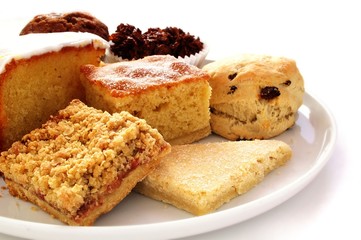 selection of baked cakes on white platter