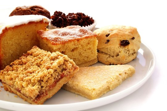 selection of baked cakes on white platter