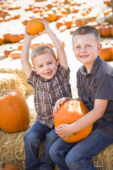 Fototapeta premium Two Boys at the Pumpkin Patch Talking and Having Fun.