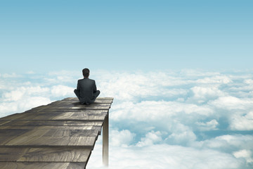 businessman sitting on pier