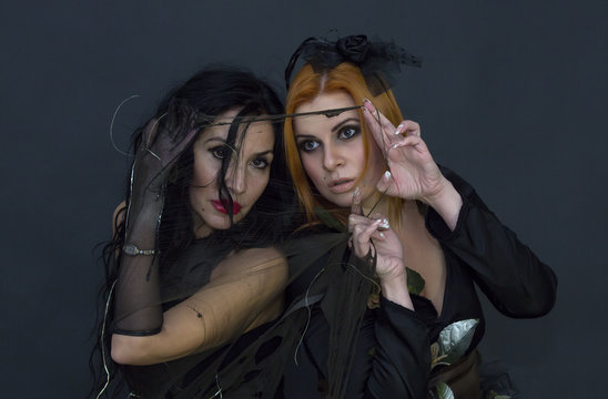 two witches on a black background