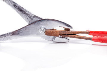 shiny pliers biting rusty ones