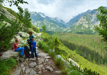Fototapeta premium High Tatras (Slovakia) summer view and family on footway.