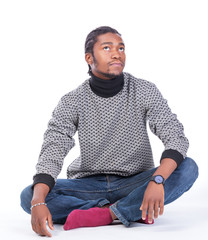 Young African-American male sitting on the ground