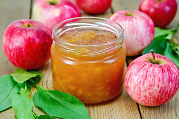 Jam apple with apples and leaves on the board