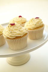 decorated cup cakes on cake stand