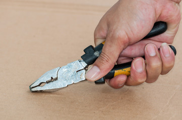 Fototapeta premium Hand with pliers