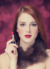 Woman in luxury fur scarf with lipstick