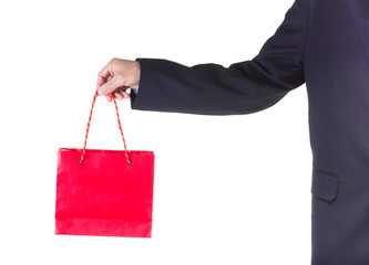 Hand holding red shopping bag.