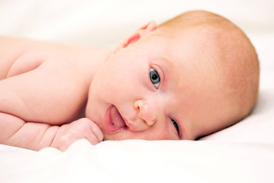 beautiful newborn baby winking