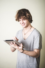 stylish young blonde hipster man using tablet