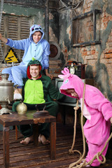 Father, mother in colorful costumes of dragons and daughter