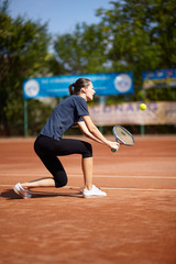 Tennis player executing a backhand volley