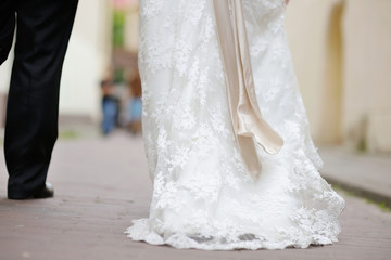 Bride and groom legs walking away