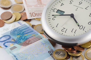 time is money with standing clock and euro's