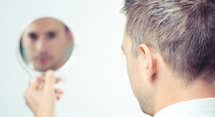 ego man reflection in mirror on a white background - obrazy, fototapety, plakaty