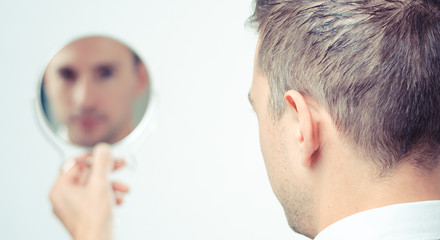 ego man reflection in mirror on a white background