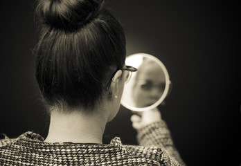 businesswoman looking in the mirror and reflecting