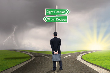 Businessman looking at sign of right vs wrong decision
