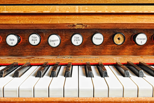 Antique organ keyboard with stops