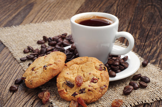Cup of coffee and cookies with raisins