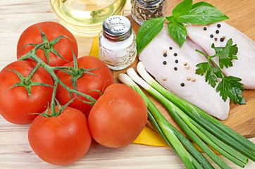 Raw chicken breasts on cutting board