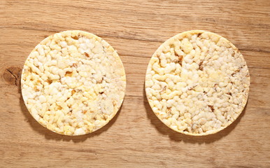 Thin round corn cakes on wooden background