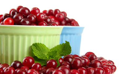Ripe red cranberries in bowls, isolated on white.