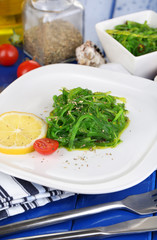 Sea kale on plate on wooden table close-up