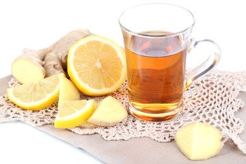 Cup of tea with ginger on napkin isolated on white
