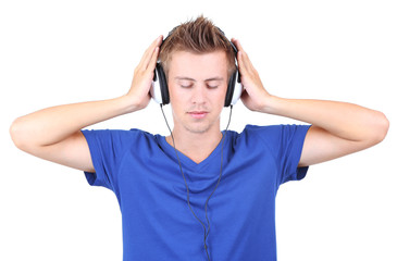 Fototapeta premium Handsome young man listening to music isolated on white