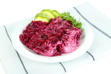Beet salad on plate on napkin isolated on white
