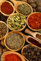 Many different spices and fragrant herbs close-up background