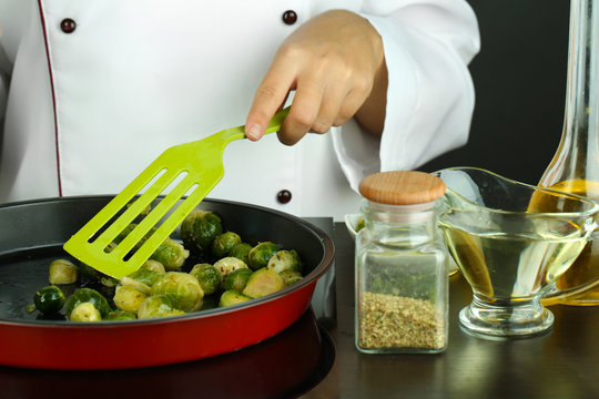 Chef prepares frresh brussels sprouts in pan