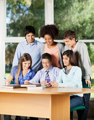 Teacher Explaining Students In Classroom