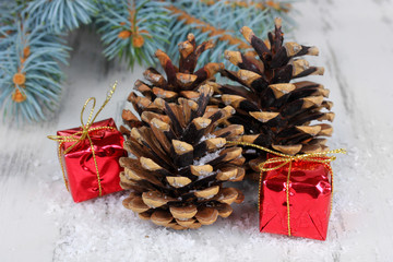 Christmas decoration with pine cones on wooden background