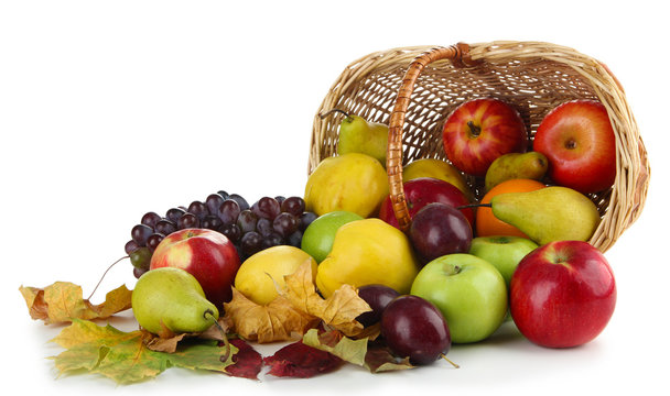 Different fruits with basket and yellow leaves isolated on