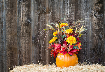 Pumpkin flower arrangement on hay