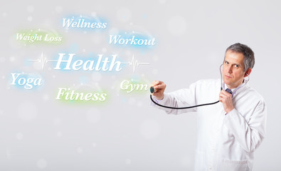 Clinical doctor pointing to health and fitness collection of wor