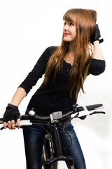 Obraz na płótnie Canvas The young girl with bike.