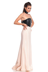 Naklejka premium side view of a young woman in long evening dress