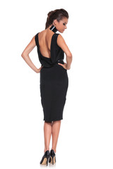 woman in a black dress with naked back