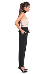 Fototapeta premium side view of a young woman with hands in her pockets