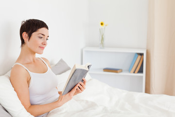 Close up of a young woman reading a book
