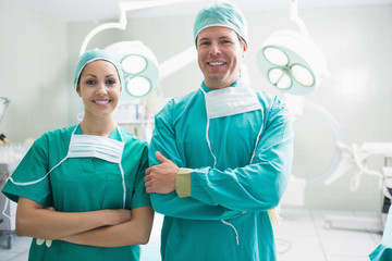 Smiling surgeons looking at camera - obrazy, fototapety, plakaty