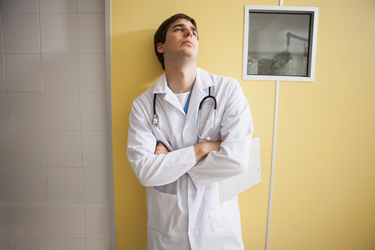 Tired Doctor Standing Hospital Room