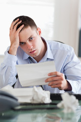 Naklejka premium Close up of businessman worried about bills