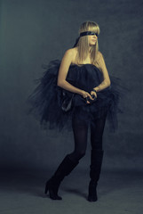 female beauty-portrait with tutu in front of a dark background