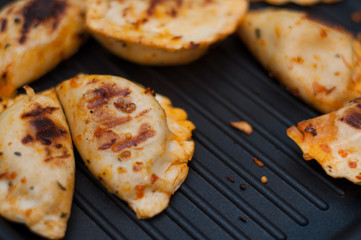 Spicy dumplings on frying pan